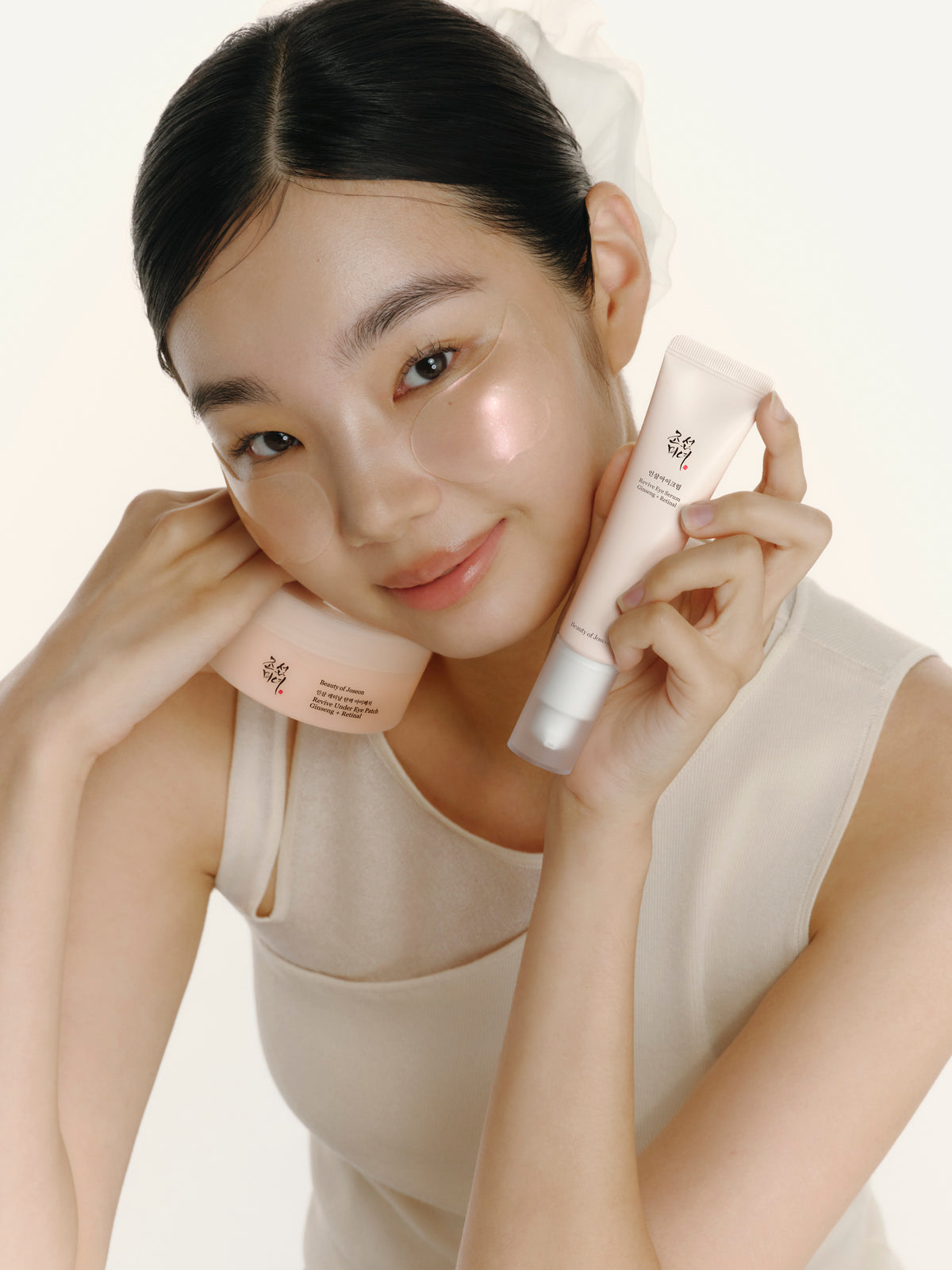 a woman holding a cream tube and smiling