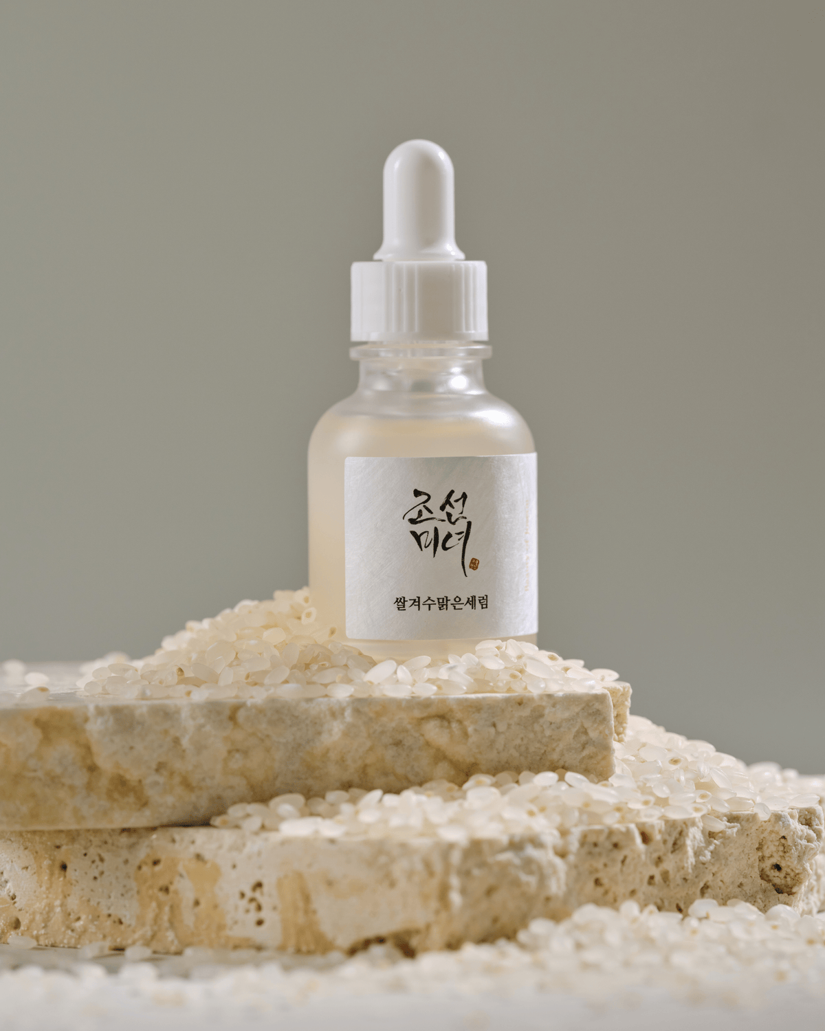 a small bottle of liquid on a pile of rocks