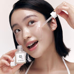a woman with a dropper on her face