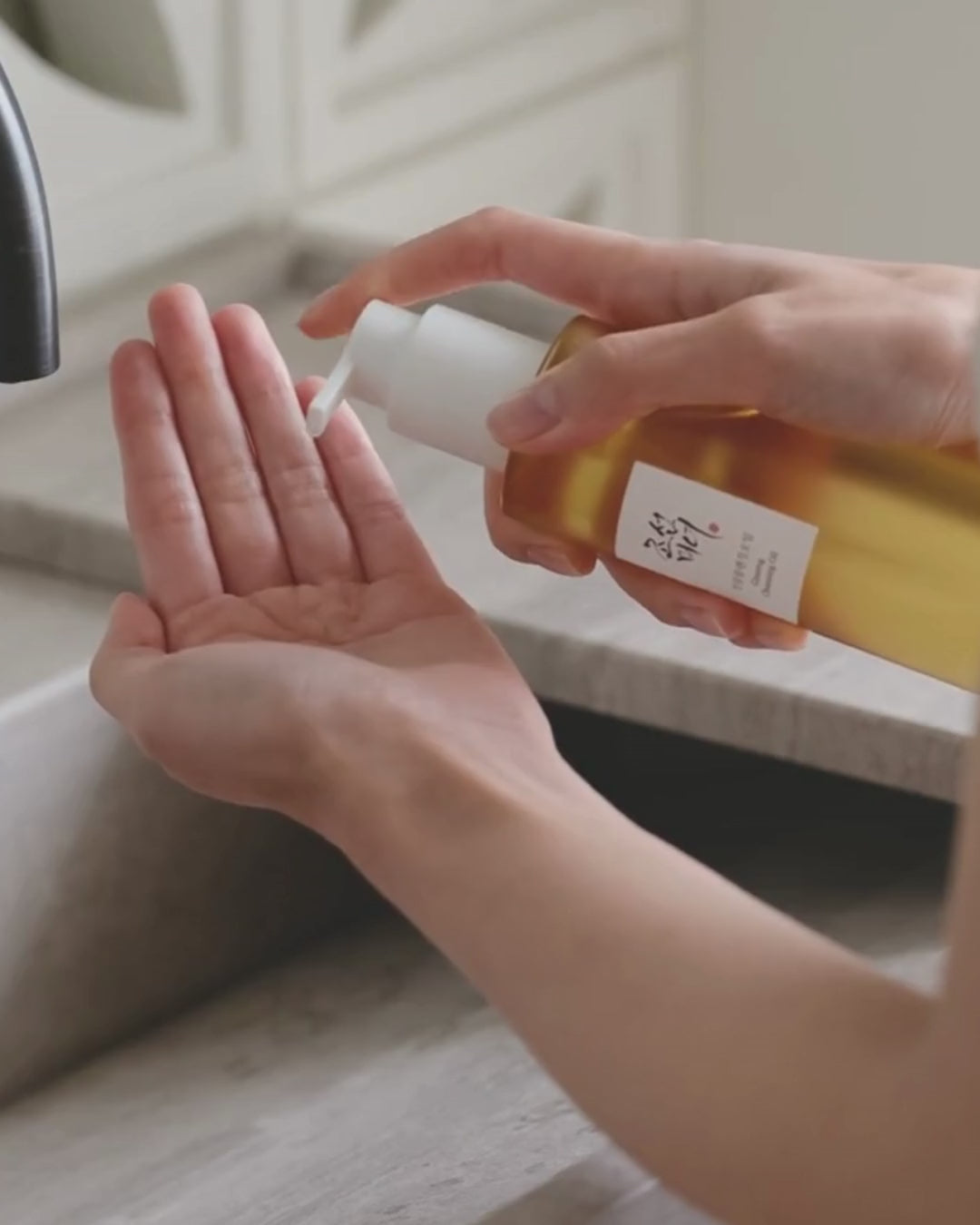 Massaging Hand with Ginseng Cleansing Oil - video background